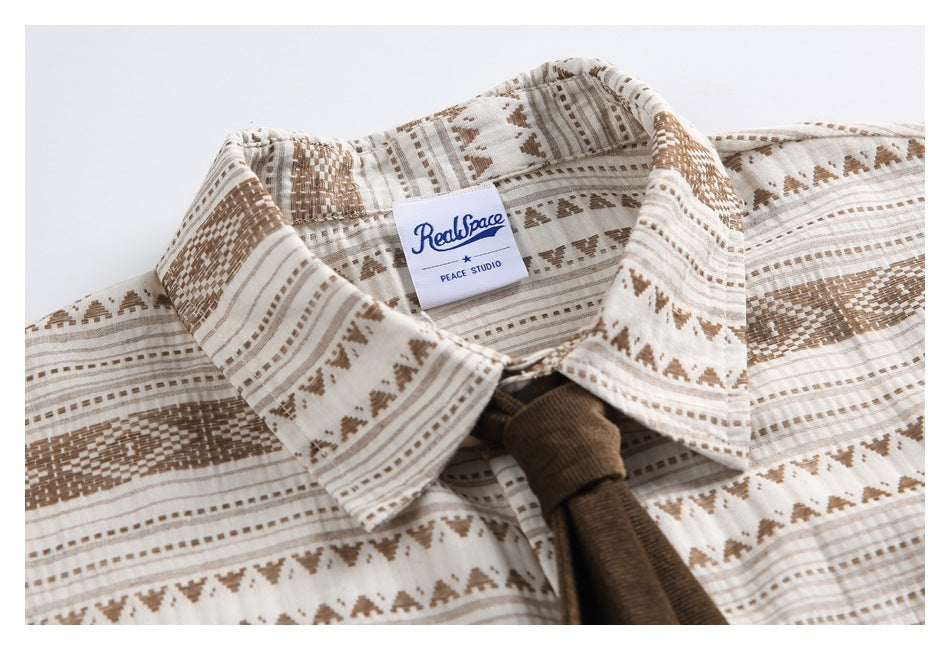 Close-up of the patterned shirt collar and an attached RealPeace / Peace Studio label.