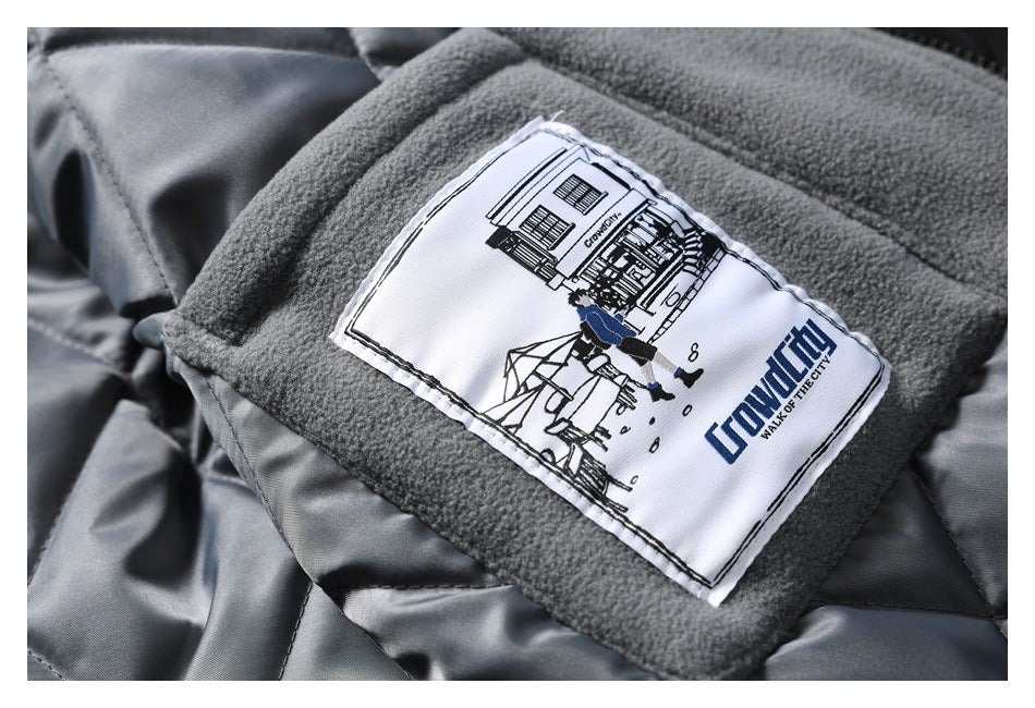 Close-up of a sewn illustrated label on gray fleece lining, with English text and a blue graphic.