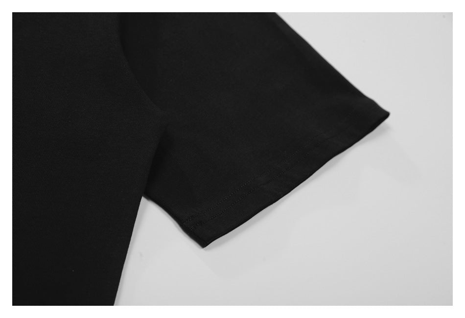 Close-up of the black T-shirt's short sleeve and double-stitched hem.