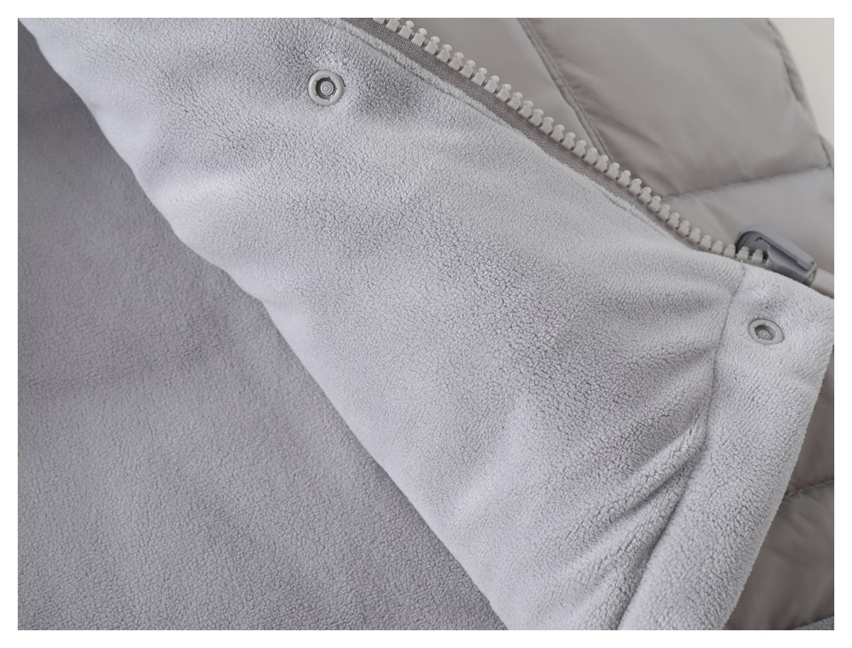 Close-up of the light gray jacket's fleece interior, zipper, and snap fasteners.