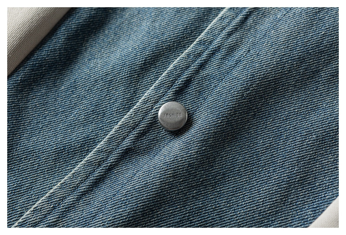 Close-up of a metal button stamped “FASHION” on blue denim fabric.