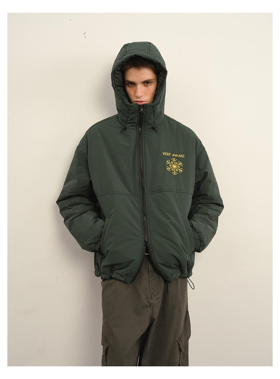 Front view of a model wearing a dark green hooded zip jacket with yellow chest embroidery.