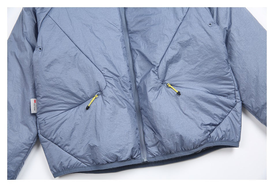 Cropped flat-lay front of a blue-gray jacket with a center zipper, angled pockets, yellow cord pulls and snap details.