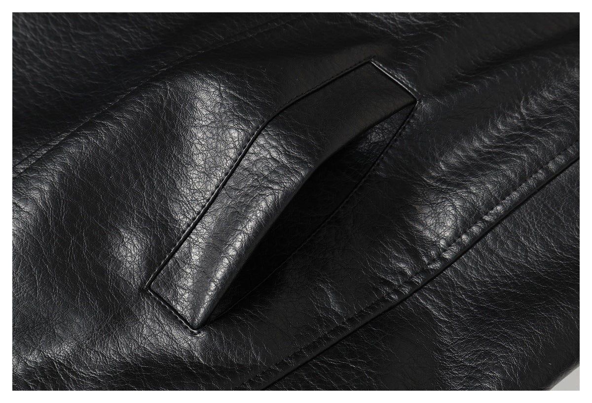 Close-up of a black jacket's narrow welt pocket and stitched panel seams.