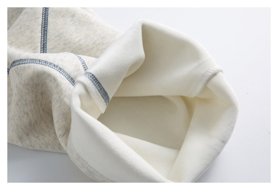 Close-up of a jogger leg opening turned inside out, showing the pale interior and blue-gray stitching.