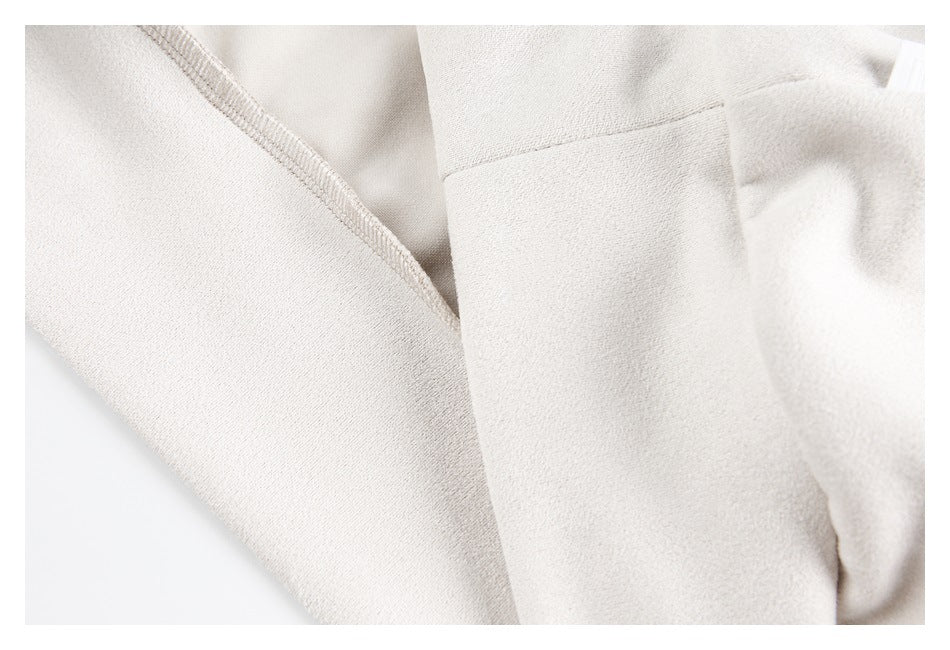 Close-up of pale cream garment panels and an overlocked seam.