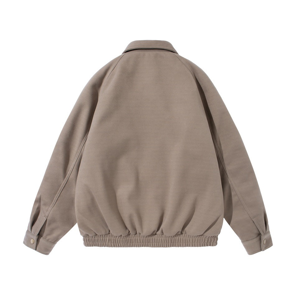 Back view of khaki jacket with raglan sleeves, pointed collar, buttoned cuffs and elastic gathered hem