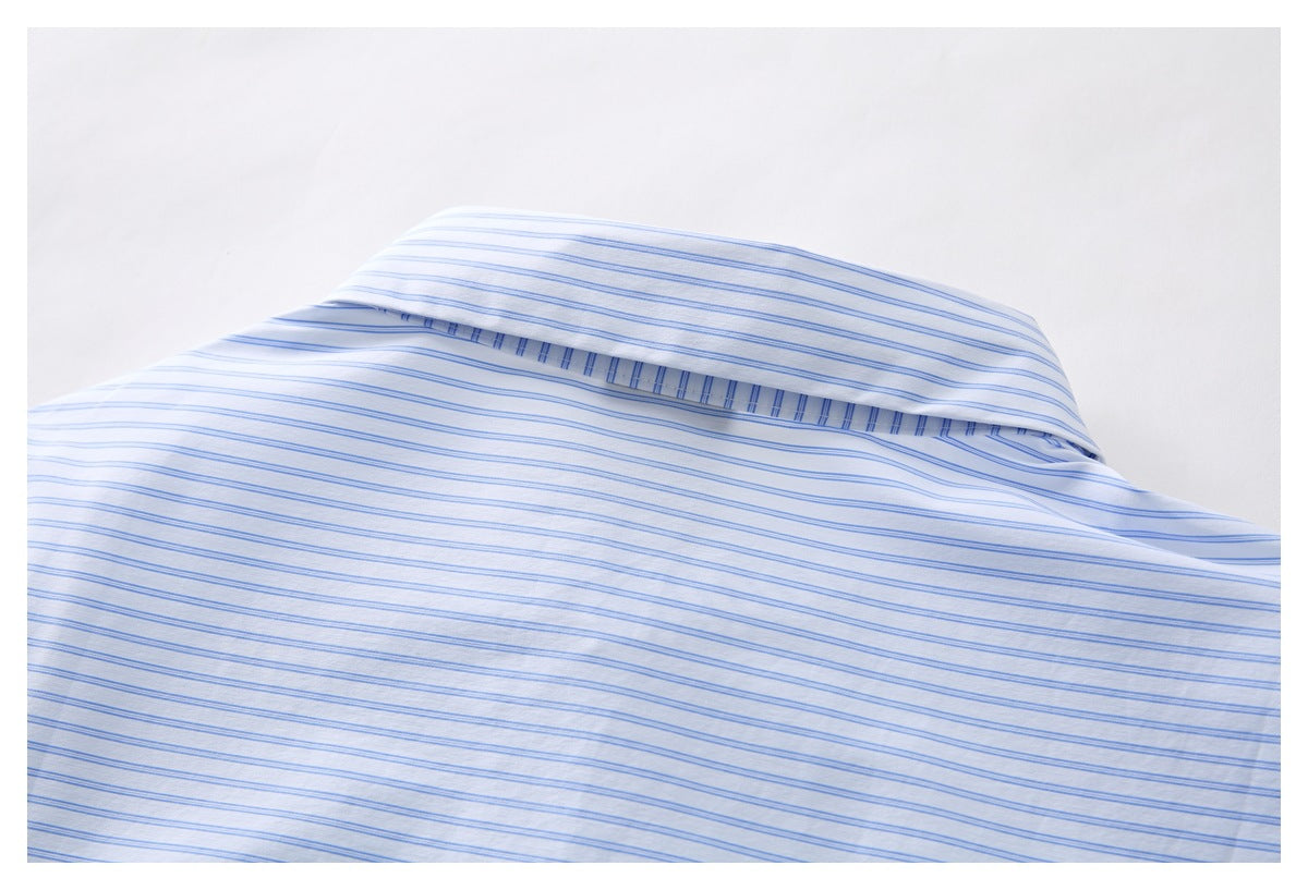 Close-up of the folded collar and striped fabric of a white shirt.