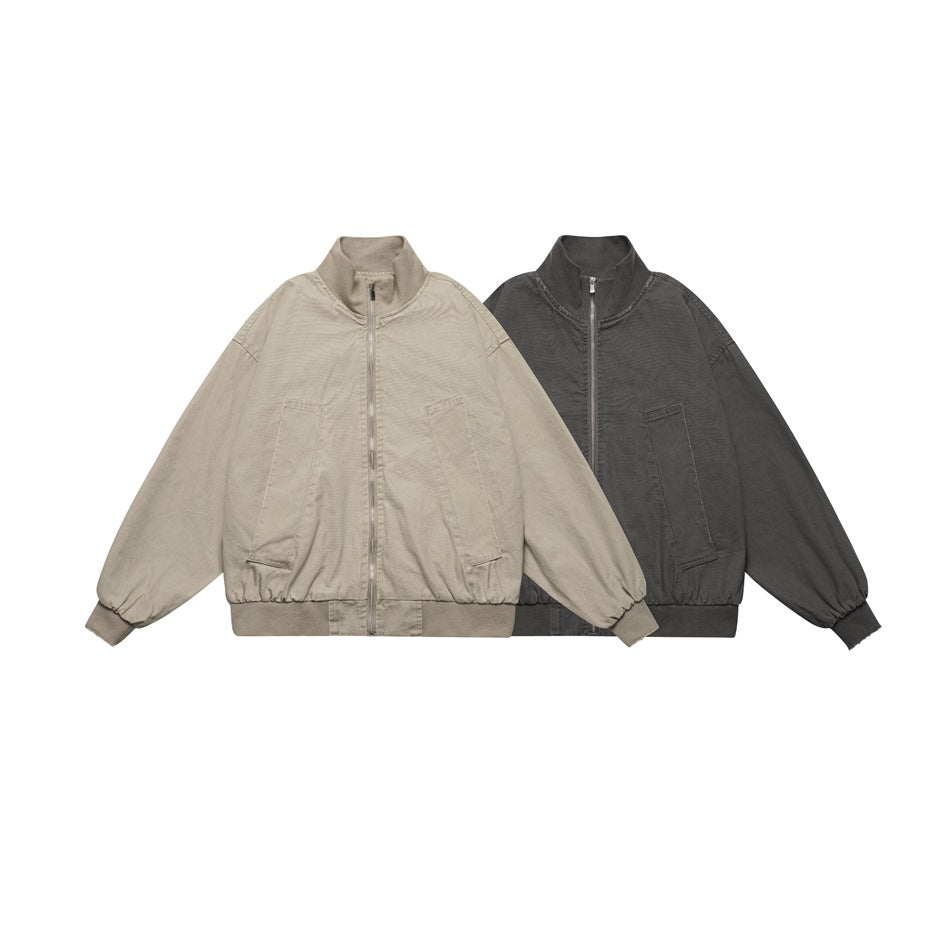 Two front-facing zip jackets with stand collars and pockets, in taupe and charcoal.