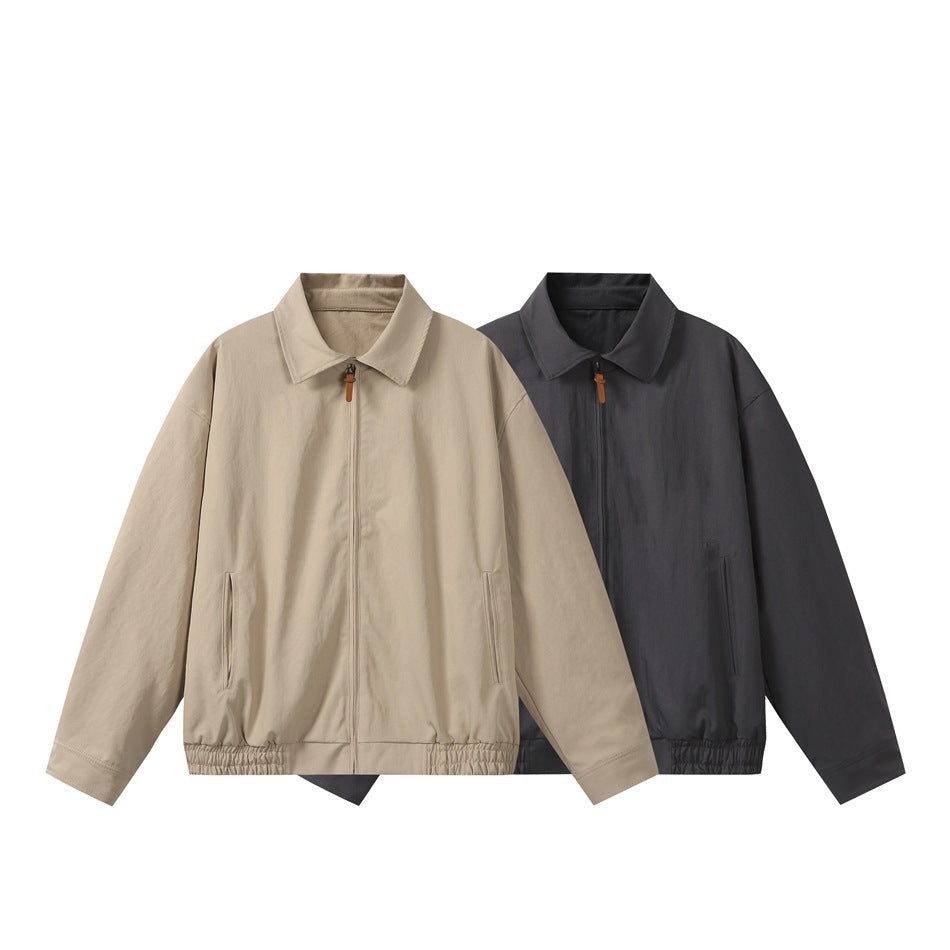 Two front views of collared zip jackets, one beige and one charcoal, with side pockets and gathered hems.