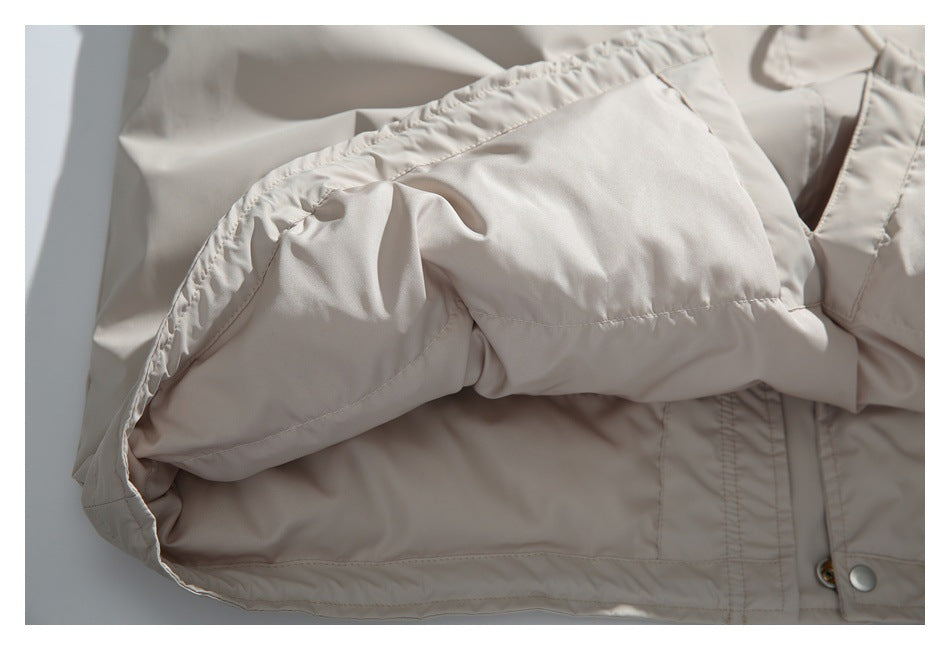 Close-up of a beige jacket sleeve cuff and stitched construction.