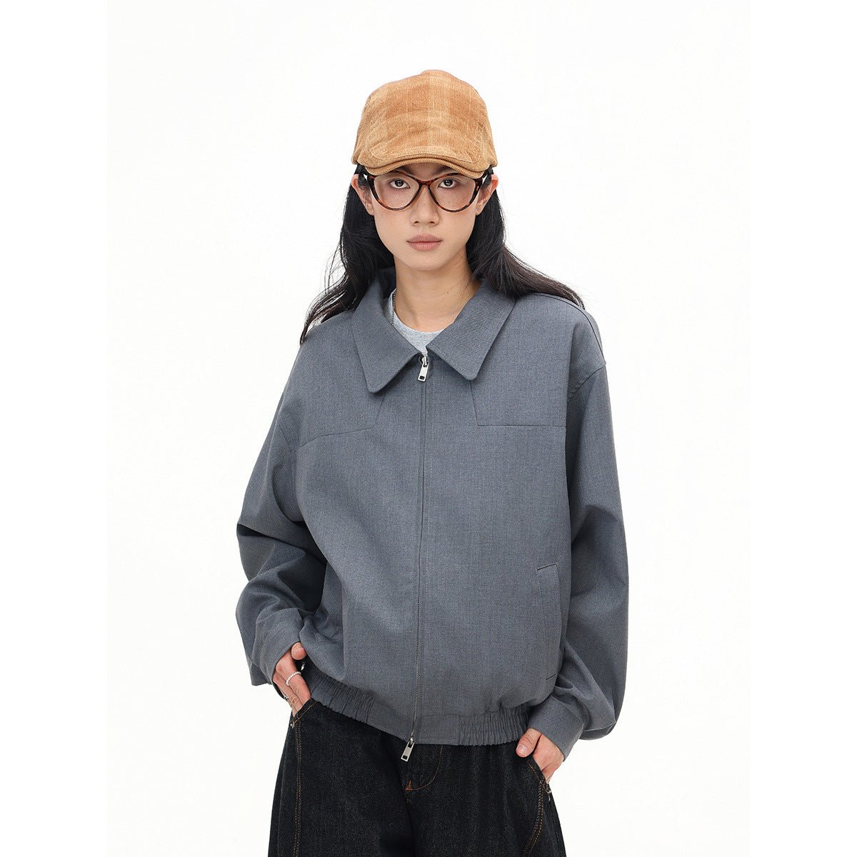 Model wearing a gray zip-front jacket with a wide collar, elastic hem and roomy sleeves.