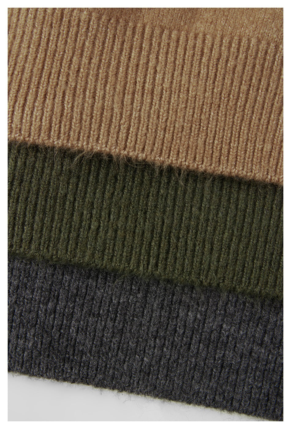 Close-up of ribbed knit bands in camel, olive green, and charcoal gray.