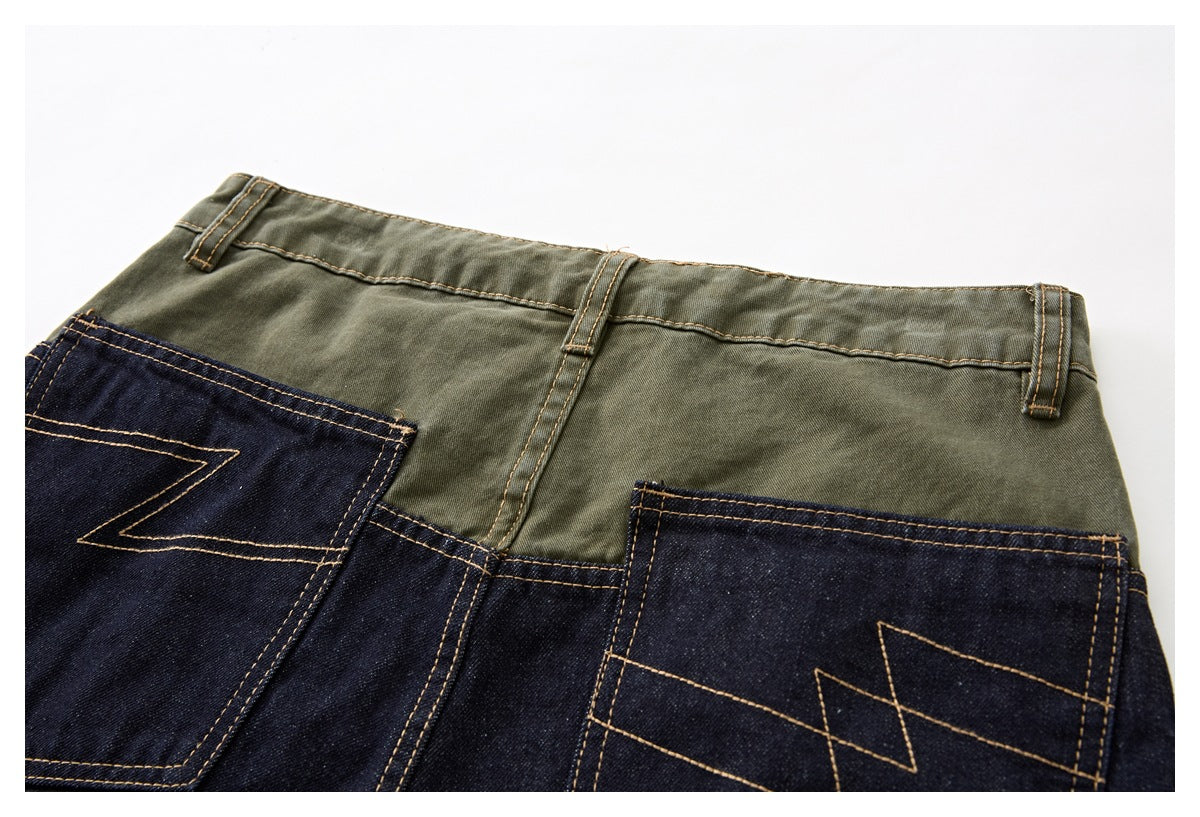 Back view of two-tone trousers with an olive waistband, dark denim panels, belt loops, and stitched pockets.