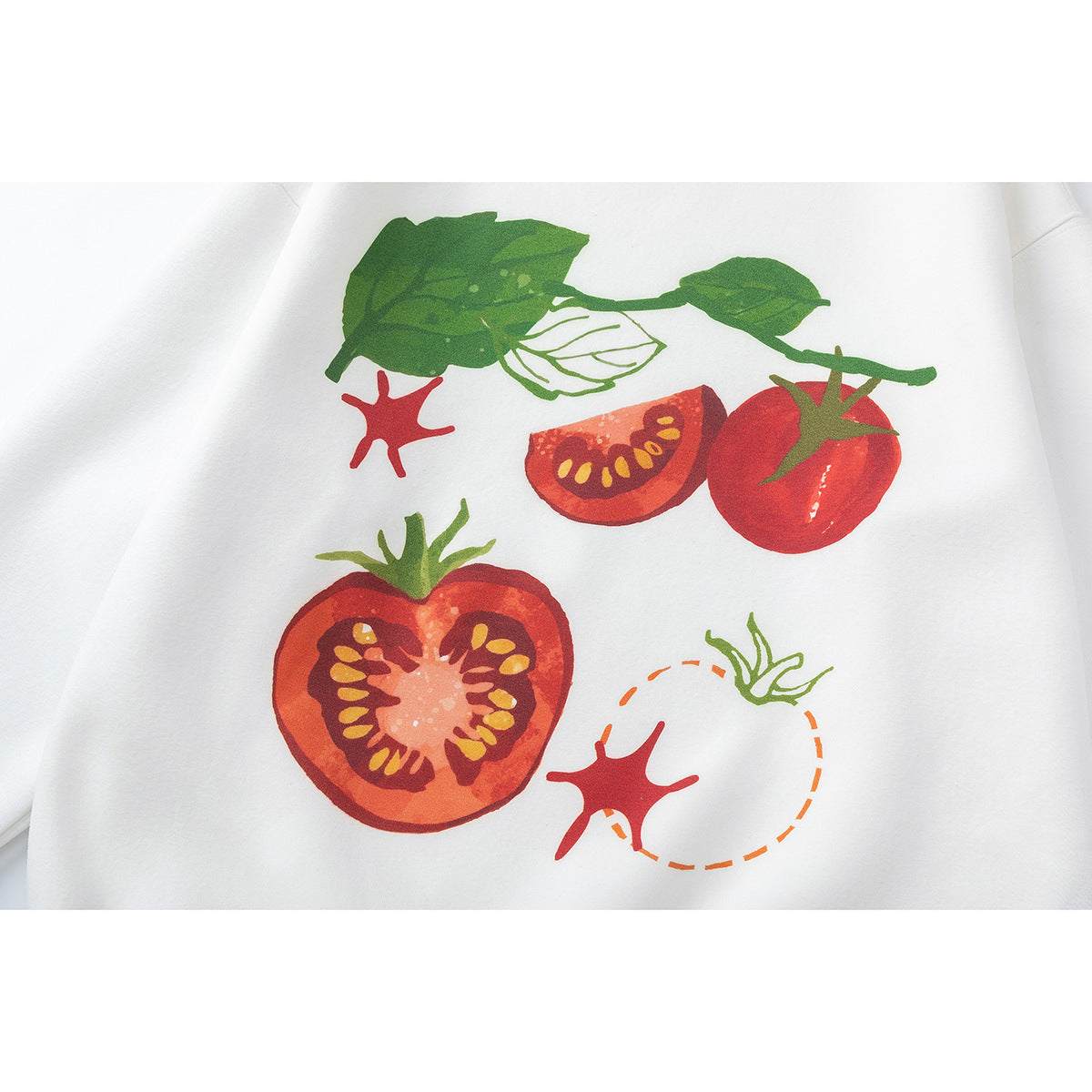 Close-up of a white garment printed with red tomatoes, green leaves and tomato slices.