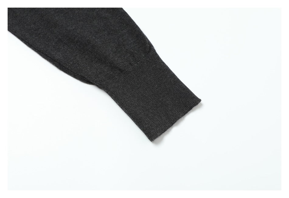 Close-up of a charcoal sleeve ending in a wide ribbed cuff on a white background.