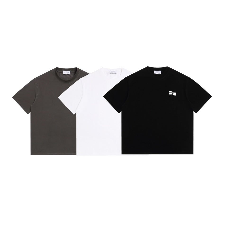 Front views of three crew-neck T-shirts in charcoal gray, white, and black; the black shirt has a small white chest logo.
