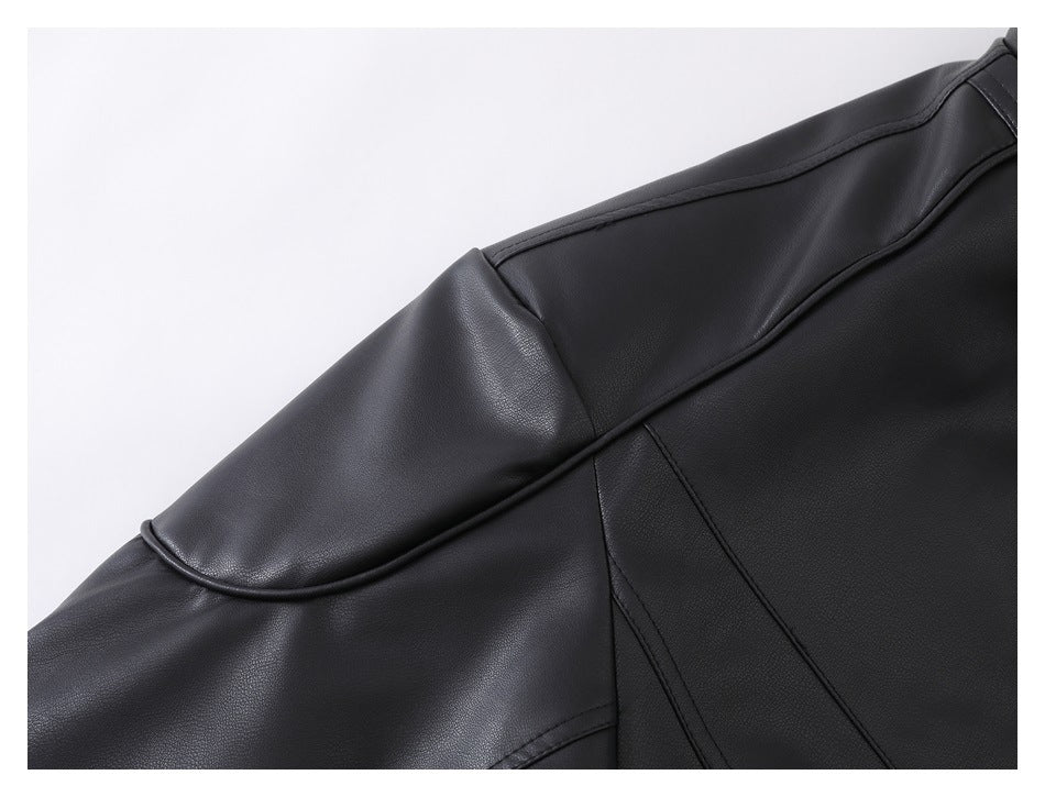 Close-up of a black jacket's shoulder and sleeve, showing curved stitched panel seams.