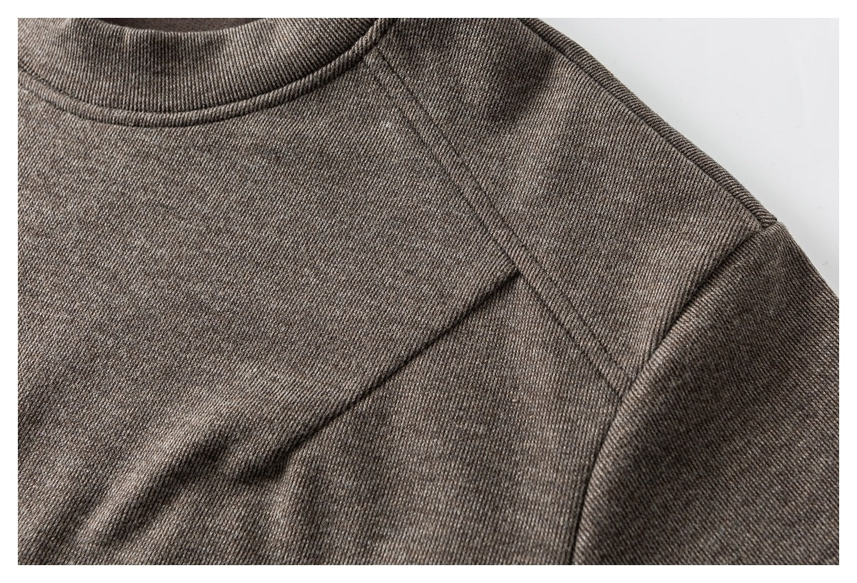 Close-up of a brown knit top showing the crew neckline and shoulder seam.
