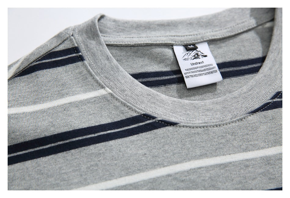Close-up of the gray striped T-shirt's ribbed neckline and sewn-in label.