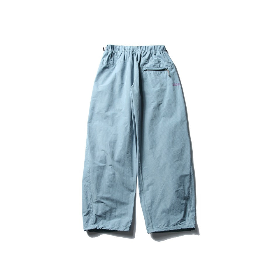 Light blue wide-leg pants shown from the back, with an elastic waist and a zip pocket.
