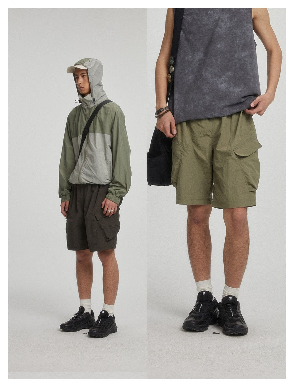 Two-panel photo of models wearing dark gray-black and army green cargo shorts styled with a hooded jacket and tank top