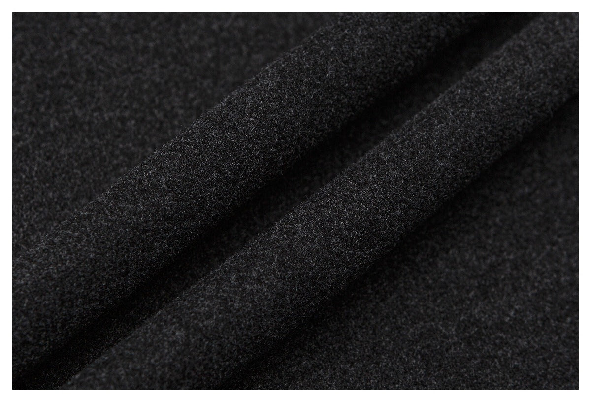 Macro view of dark charcoal fabric folded to show its soft, fine-textured surface.