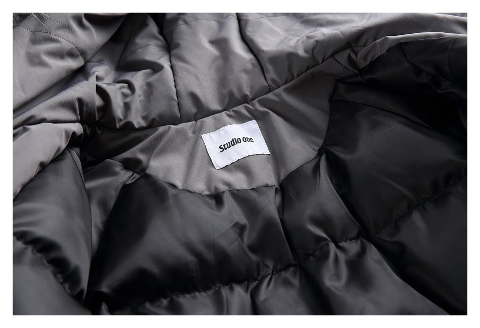 Close-up of the jacket's dark quilted lining and a white Studio One label.