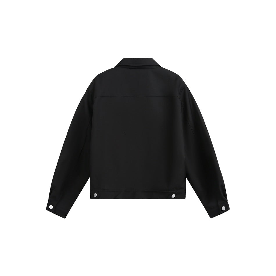 Back view of black cropped jacket with back yoke seam, snap buttons at the hem tabs and button cuffs