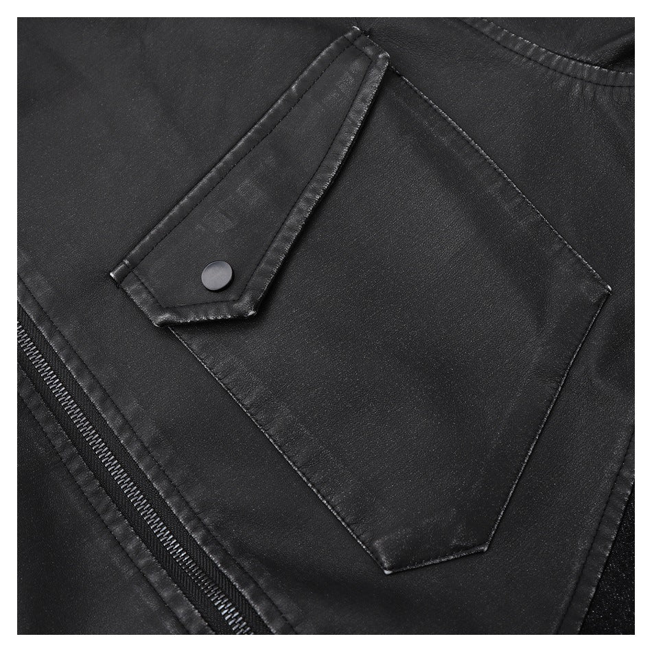 Close-up of a large angular patch pocket with a snap tab on the black jacket.