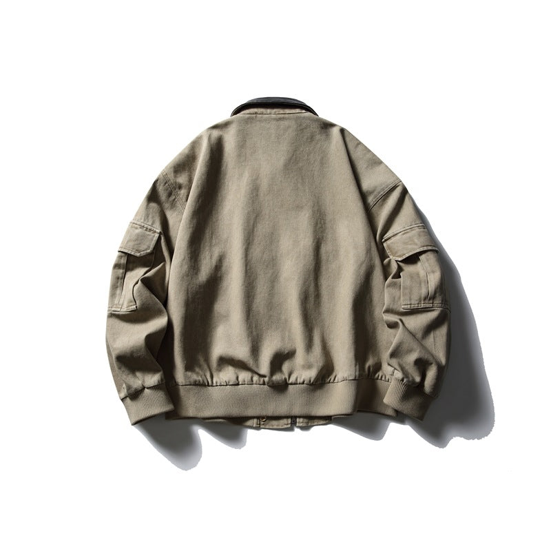 Back view of the taupe jacket with a black collar, gathered hem, and flap pockets on the sleeves.