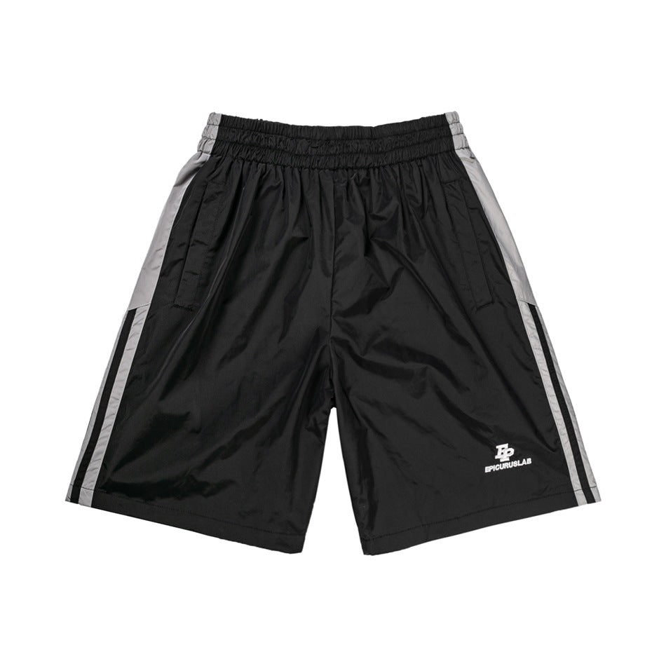 Black knee-length shorts with gray side panels, black stripes, elastic waist and small white logo, front view