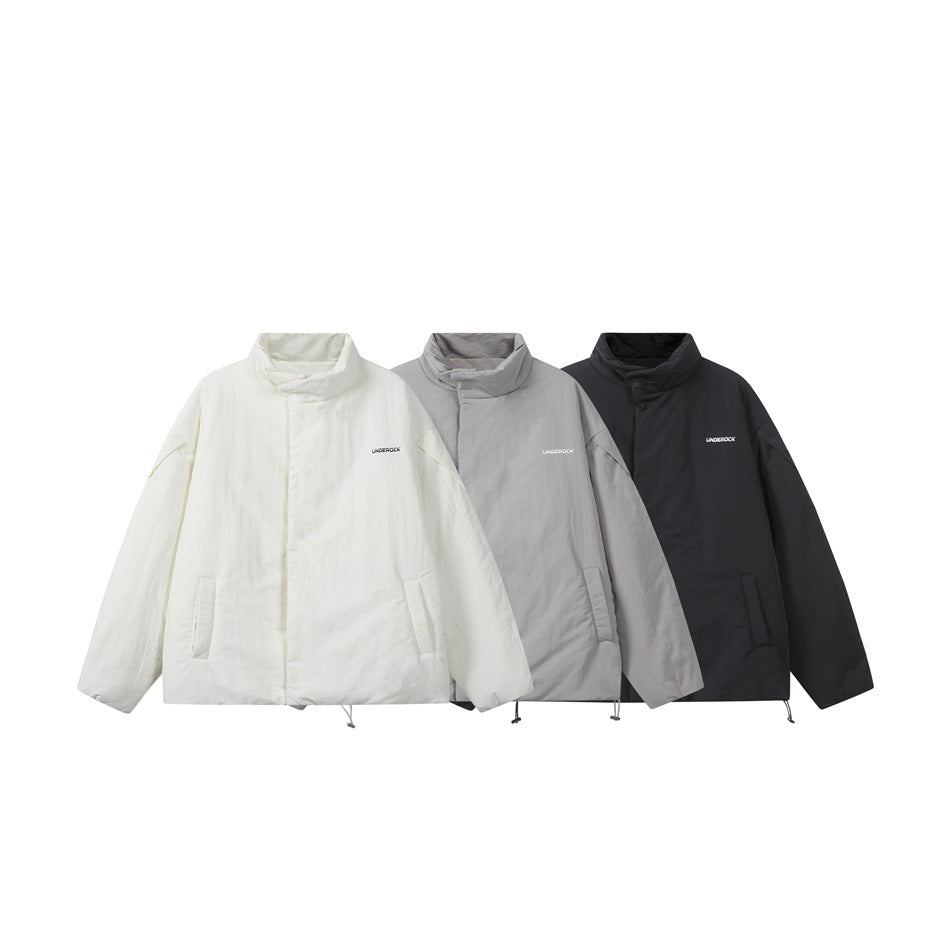 Three oversized padded jackets shown front-facing in ivory, light gray, and black, each with a high collar.
