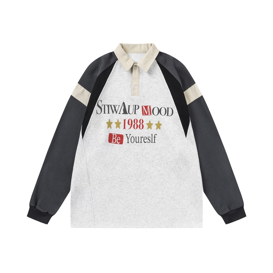 Heather gray polo sweatshirt with charcoal raglan sleeves, cream collar and stripes, and a front graphic print