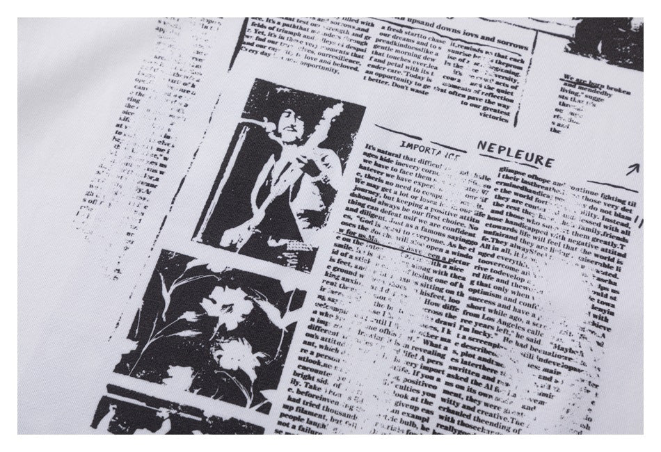Close-up of the black newspaper-style text and photo graphic printed on white fabric.