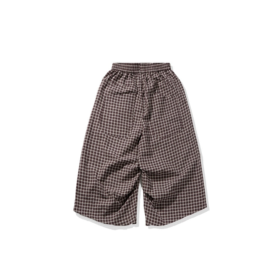Brown plaid wide-leg shorts shown flat from the front, with an elastic waistband and two front pockets.