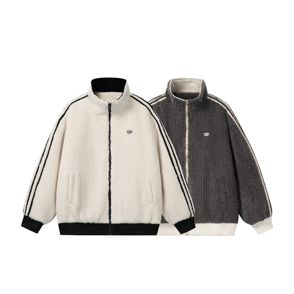 Two front views of textured zip jackets: ivory with black trim and charcoal with ivory trim.