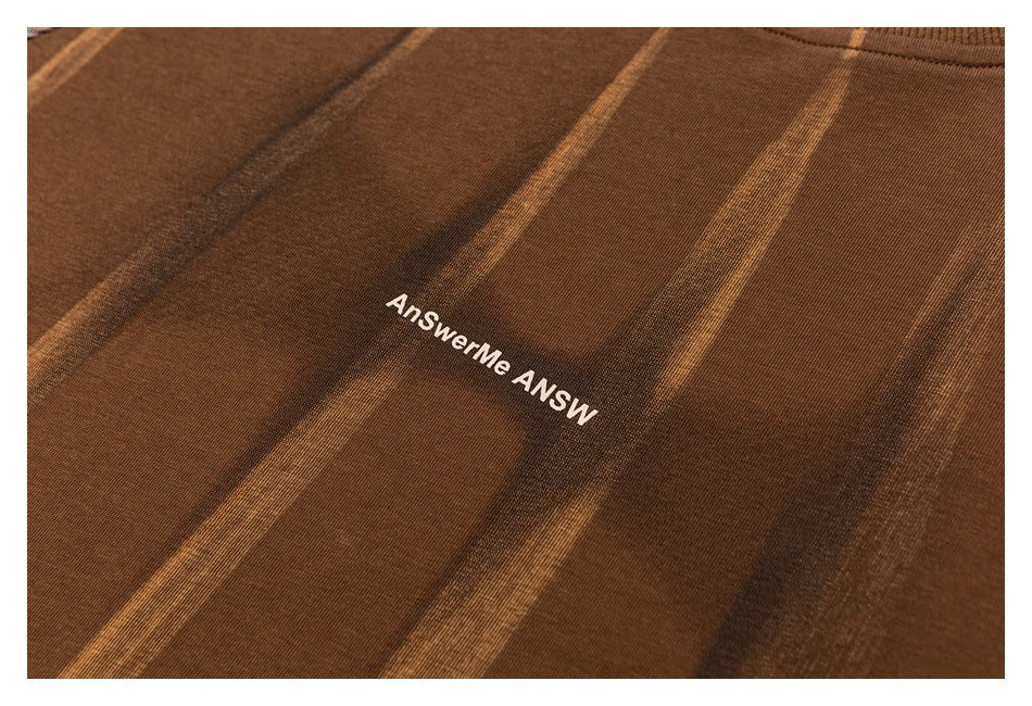 Close-up of brown striped fabric with white AnSwerMe lettering.