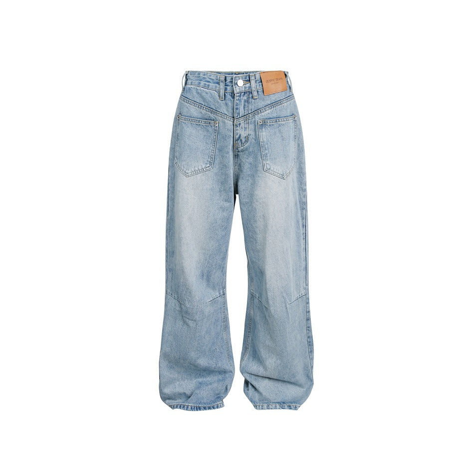 Light blue washed wide-leg jeans with patch front pockets, V-shaped yoke, knee seams and a back waist patch, flat front view