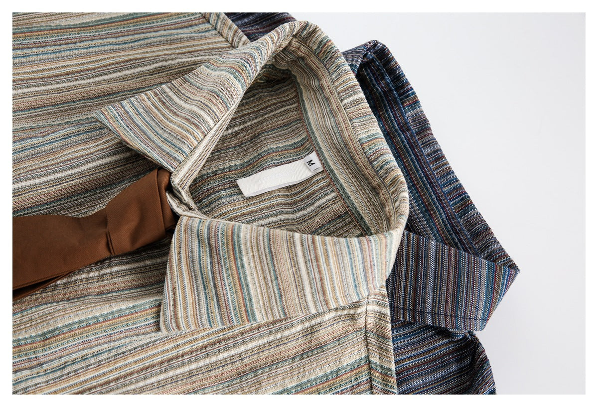 Close-up of two finely striped shirts in muted beige and dark blue colorways.