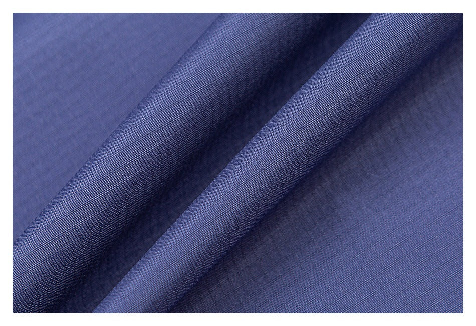 Macro view of the blue-purple jacket fabric, showing its surface and texture.