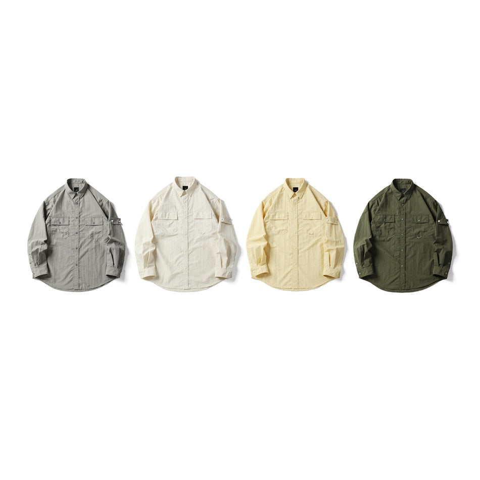 Four long-sleeve snap-front shirts laid flat in gray, ivory, pale yellow, and olive green.