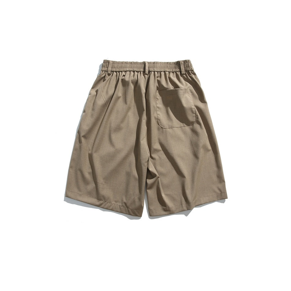 Back view of coffee-brown knee-length shorts with elastic waistband and one patch pocket