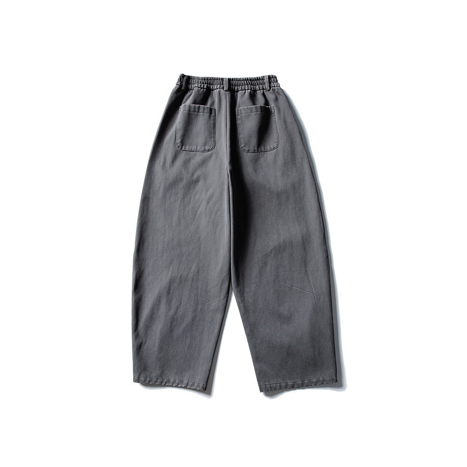 Back view of gray trousers with an elastic waistband and two patch pockets.