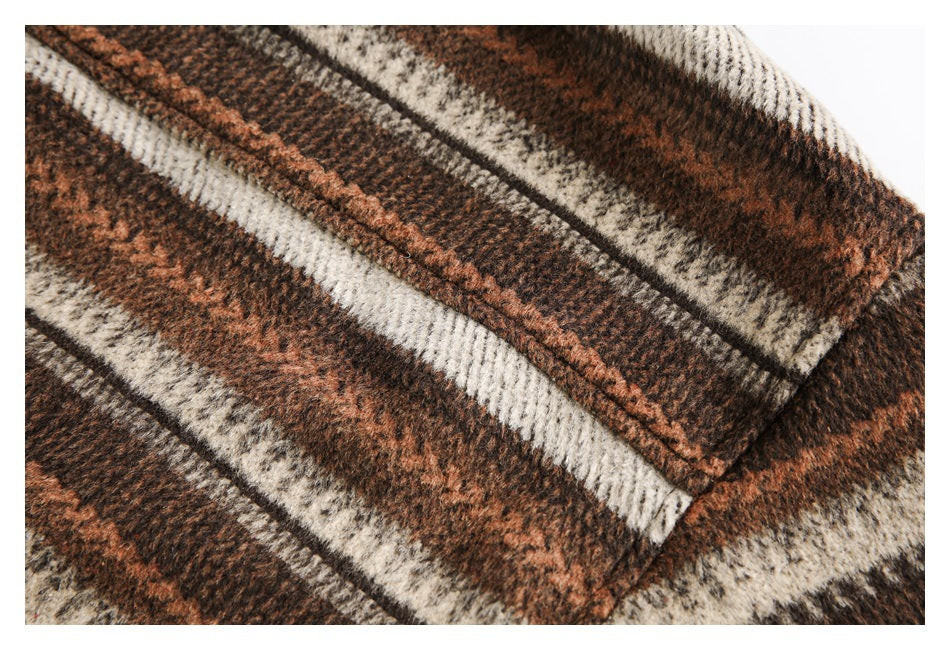 Close-up showing a stitched edge on brown, rust, and cream patterned fabric.