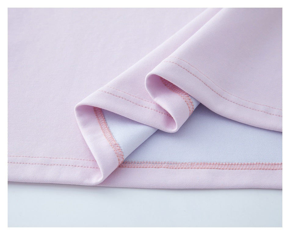 Close-up of the pale pink T-shirt's hem and overlock stitching on the inside.