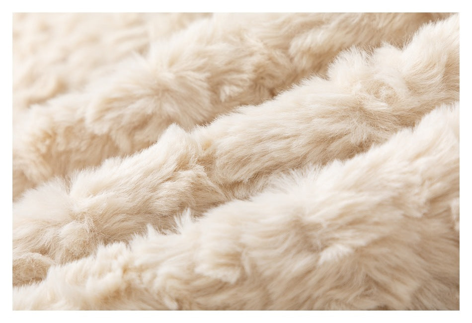 Extreme close-up showing the long, fluffy cream pile of the garment.