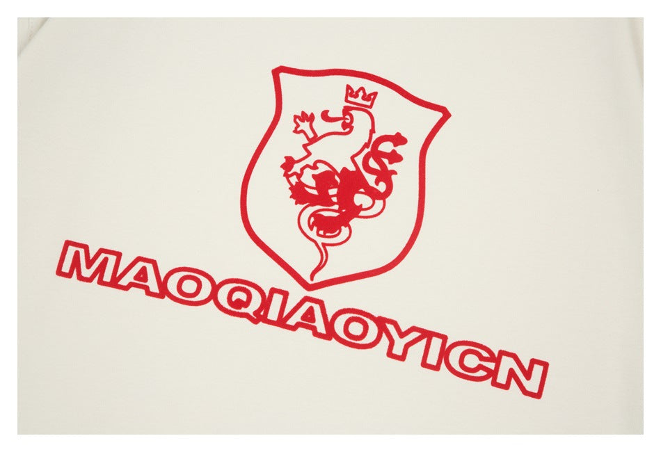 Close-up of a red outlined crest and lettering printed on off-white fabric.