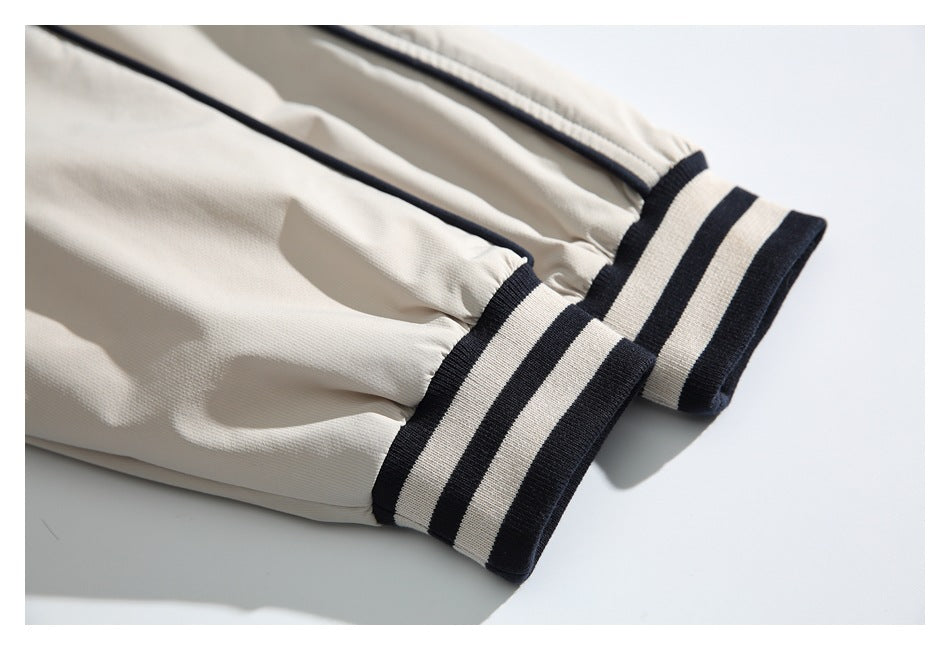 Close-up of the ivory jacket sleeves ending in dark-and-ivory striped ribbed cuffs.