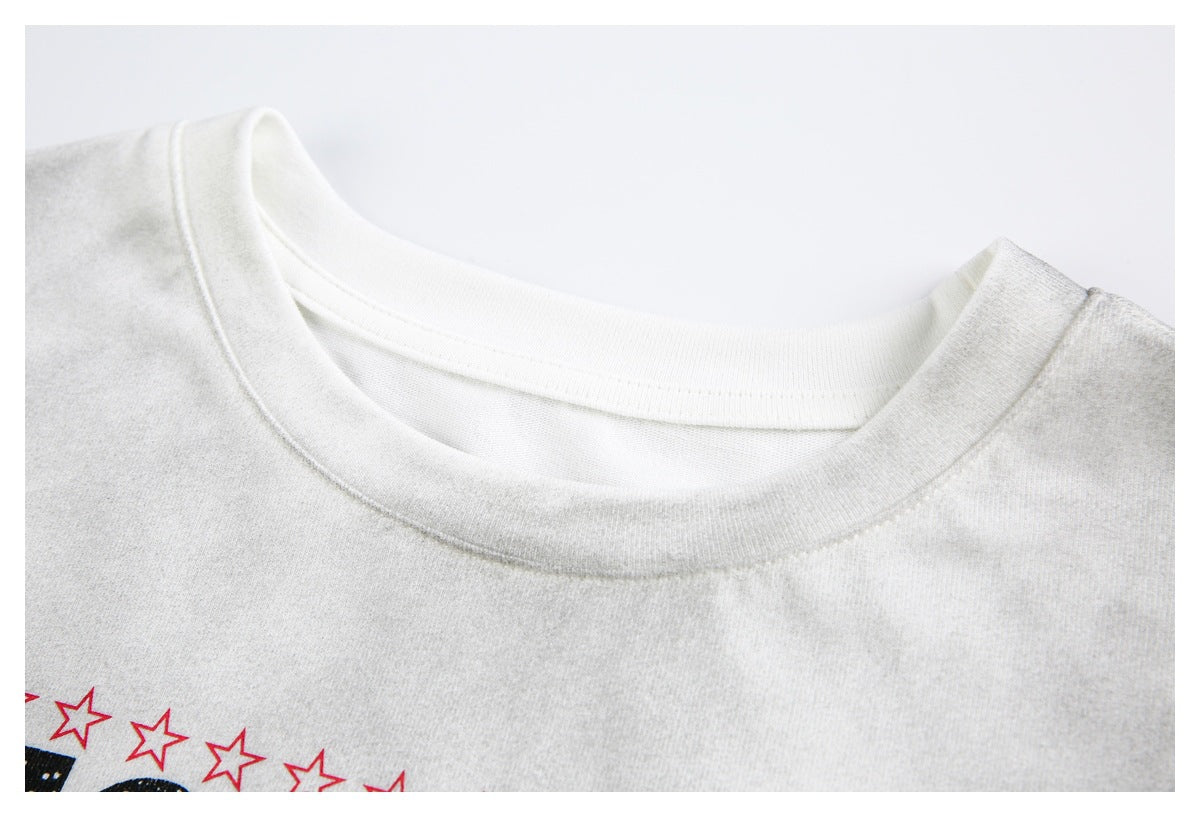 Close-up of the ribbed crew neckline and upper chest of a white graphic T-shirt.